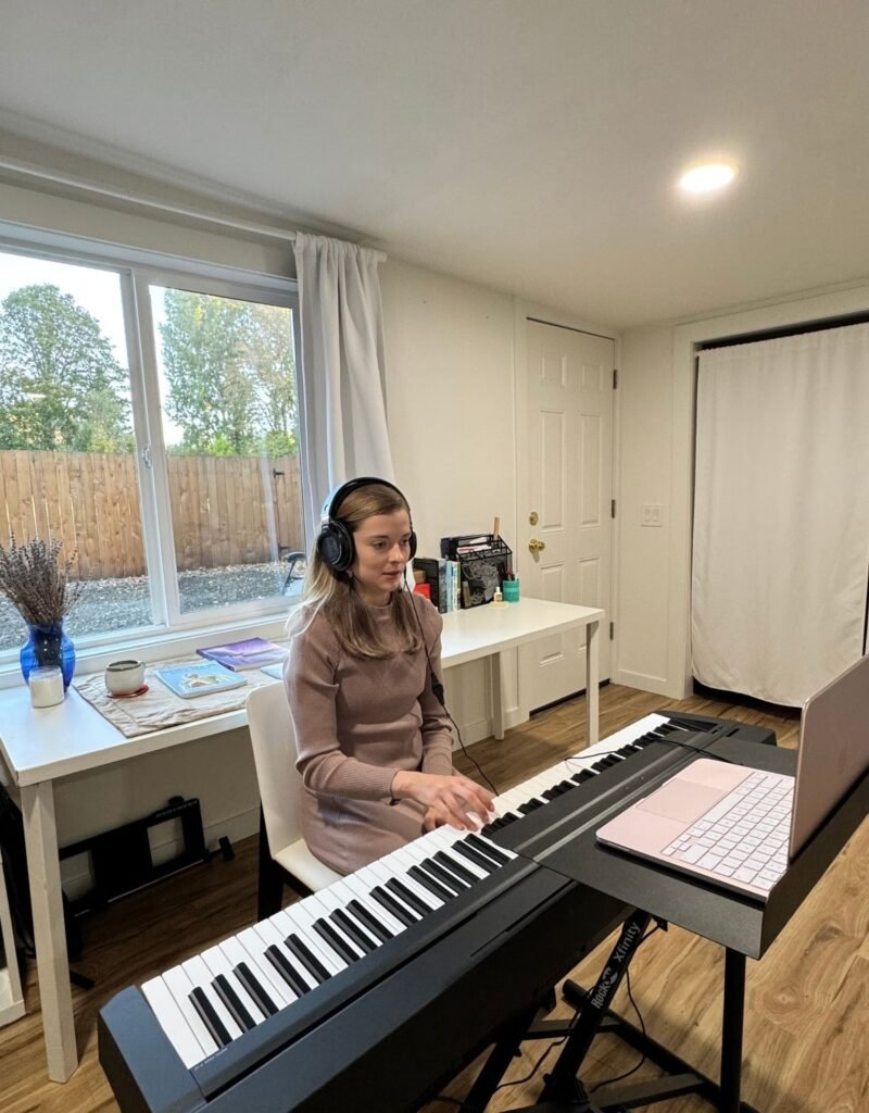 Image of Amanda helping a voice singing online student by accompanying her with her with the piano.